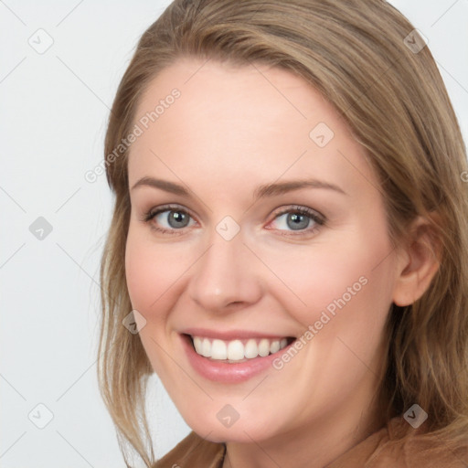 Joyful white young-adult female with long  brown hair and blue eyes