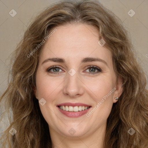 Joyful white adult female with long  brown hair and brown eyes