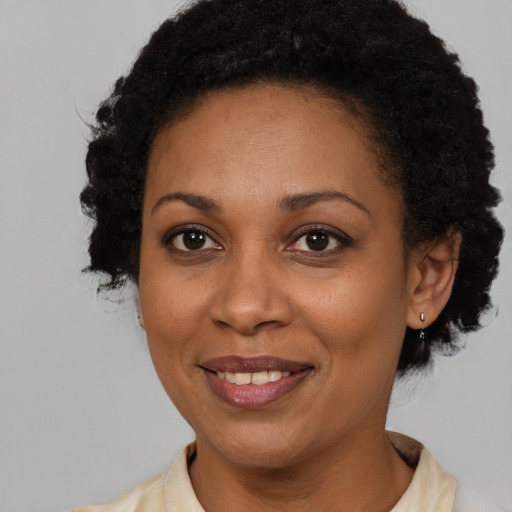 Joyful latino adult female with short  brown hair and brown eyes