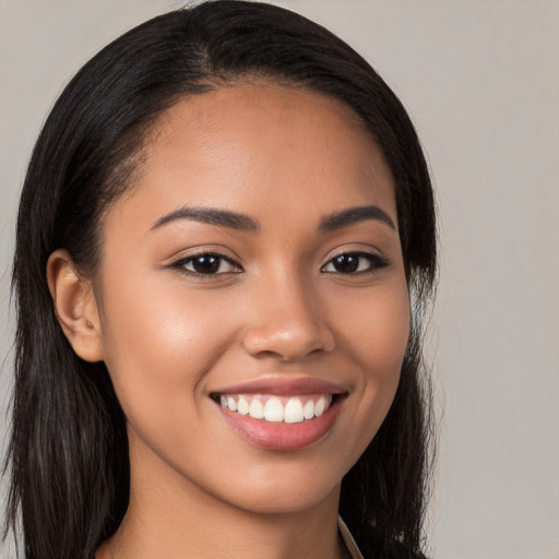 Joyful latino young-adult female with long  brown hair and brown eyes