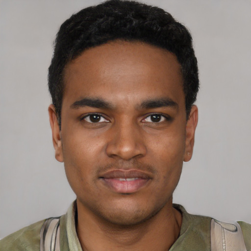 Joyful black young-adult male with short  black hair and brown eyes