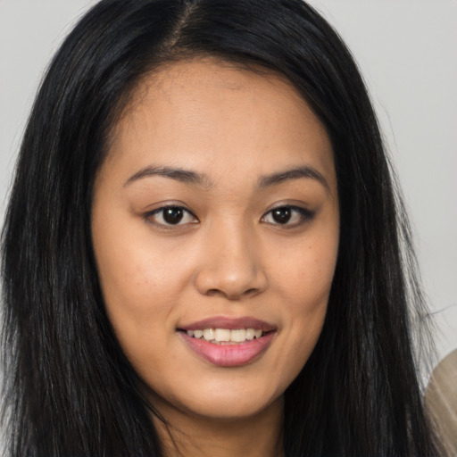 Joyful asian young-adult female with long  brown hair and brown eyes