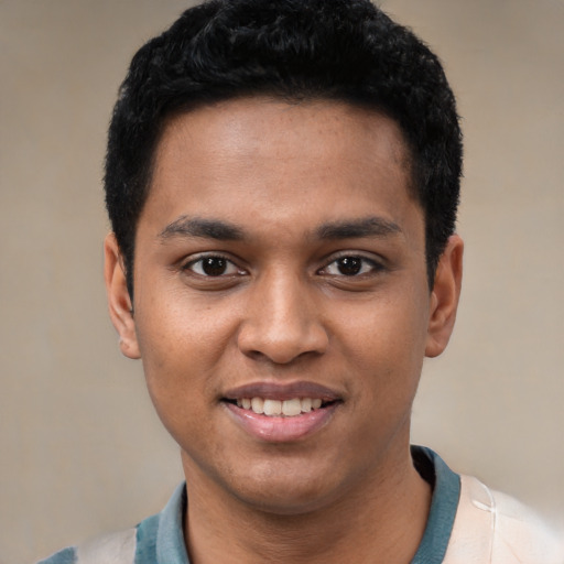 Joyful black young-adult male with short  black hair and brown eyes