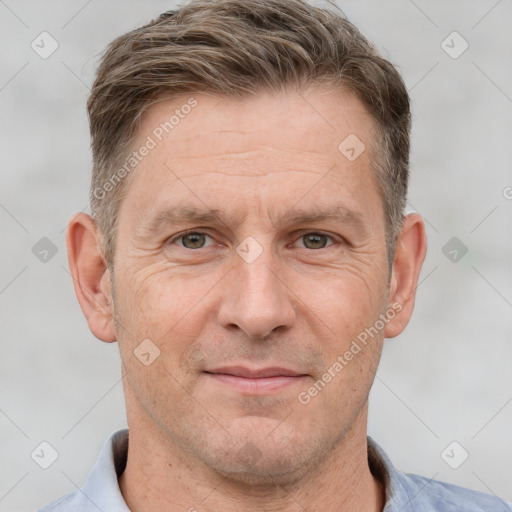 Joyful white adult male with short  brown hair and brown eyes