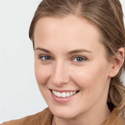 Joyful white young-adult female with long  brown hair and grey eyes