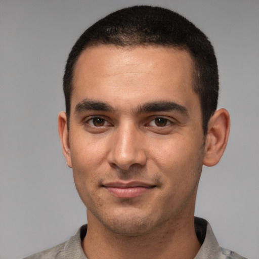 Joyful white young-adult male with short  black hair and brown eyes