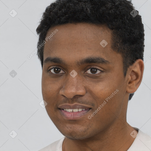 Joyful black young-adult male with short  black hair and brown eyes