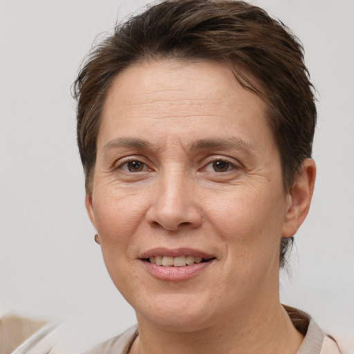 Joyful white adult female with short  brown hair and brown eyes