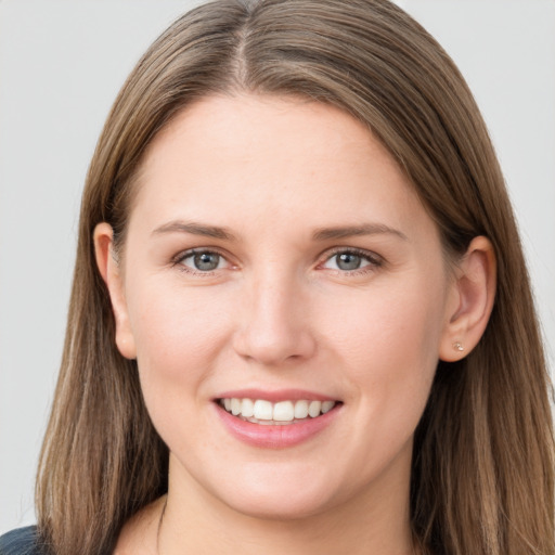 Joyful white young-adult female with long  brown hair and grey eyes