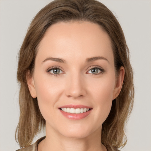 Joyful white young-adult female with long  brown hair and grey eyes