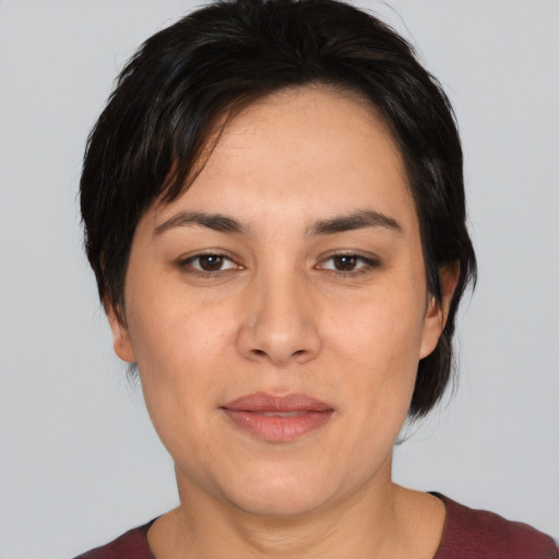 Joyful white young-adult female with medium  black hair and brown eyes