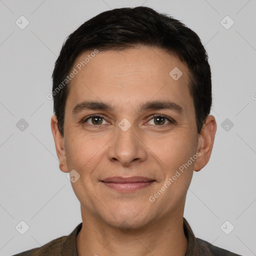 Joyful white adult male with short  black hair and brown eyes