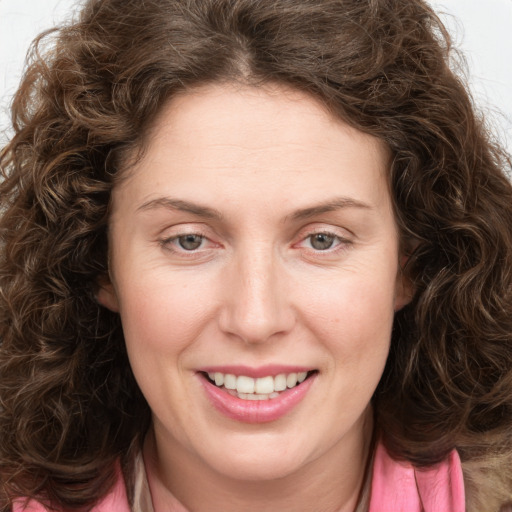 Joyful white young-adult female with long  brown hair and green eyes