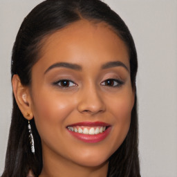 Joyful latino young-adult female with long  brown hair and brown eyes