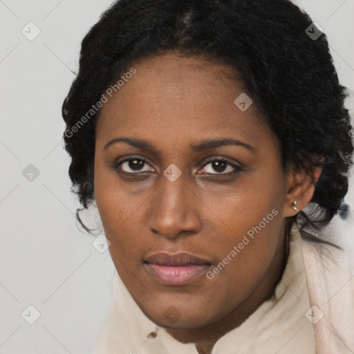 Joyful black young-adult female with long  brown hair and brown eyes