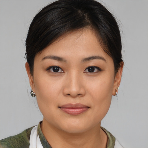 Joyful asian young-adult female with medium  brown hair and brown eyes