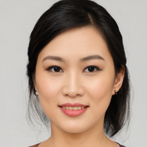 Joyful asian young-adult female with medium  black hair and brown eyes