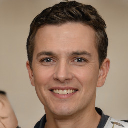 Joyful white adult male with short  brown hair and brown eyes