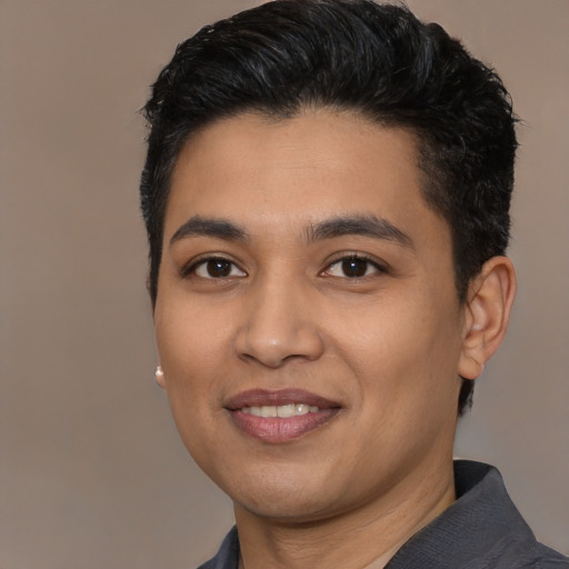 Joyful latino young-adult male with short  black hair and brown eyes