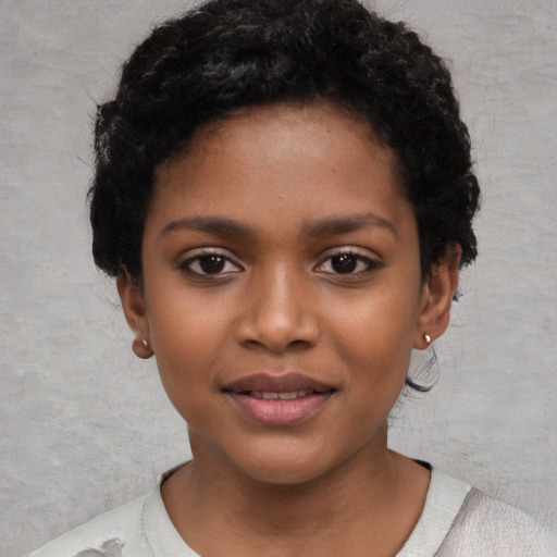 Joyful black child female with short  black hair and brown eyes