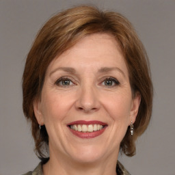 Joyful white adult female with medium  brown hair and grey eyes