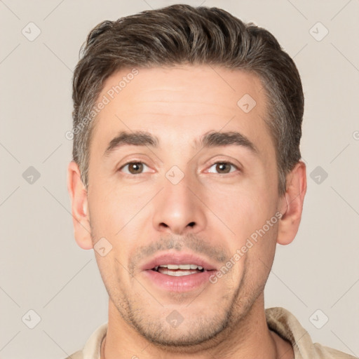 Joyful white young-adult male with short  brown hair and brown eyes