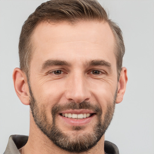 Joyful white adult male with short  brown hair and brown eyes