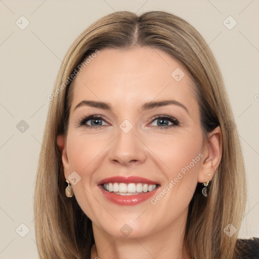 Joyful white adult female with long  brown hair and brown eyes