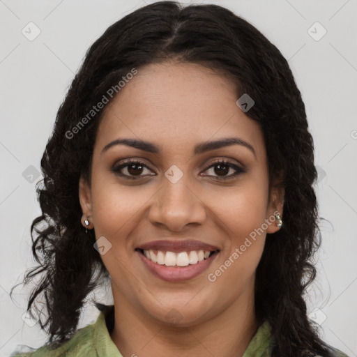 Joyful black young-adult female with long  brown hair and brown eyes