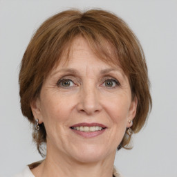 Joyful white adult female with medium  brown hair and grey eyes