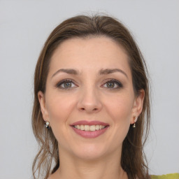 Joyful white young-adult female with medium  brown hair and grey eyes