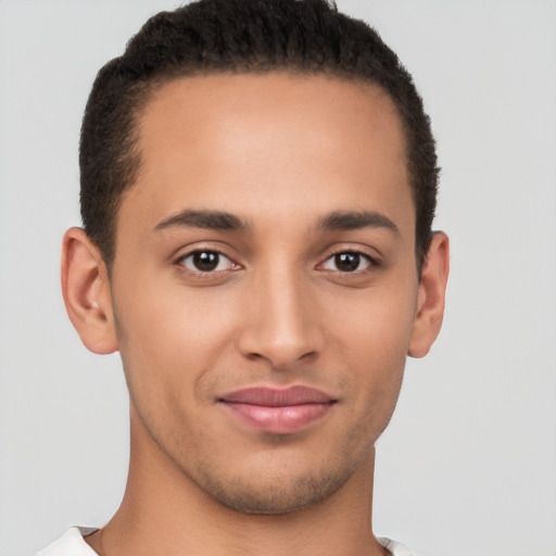 Joyful latino young-adult male with short  brown hair and brown eyes