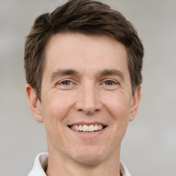 Joyful white adult male with short  brown hair and brown eyes