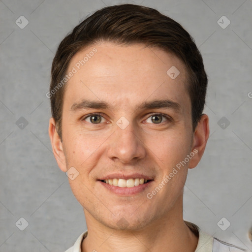 Joyful white young-adult male with short  brown hair and grey eyes