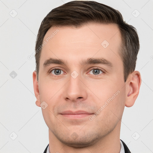 Joyful white young-adult male with short  brown hair and brown eyes