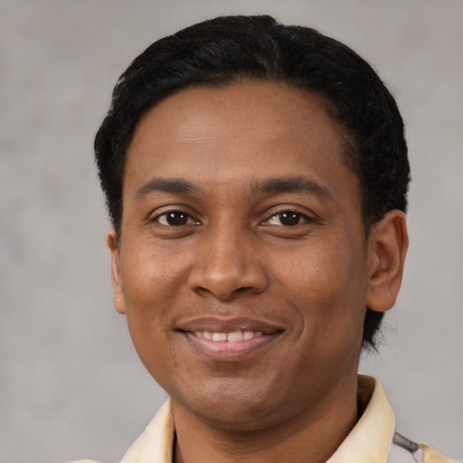 Joyful latino young-adult male with short  black hair and brown eyes