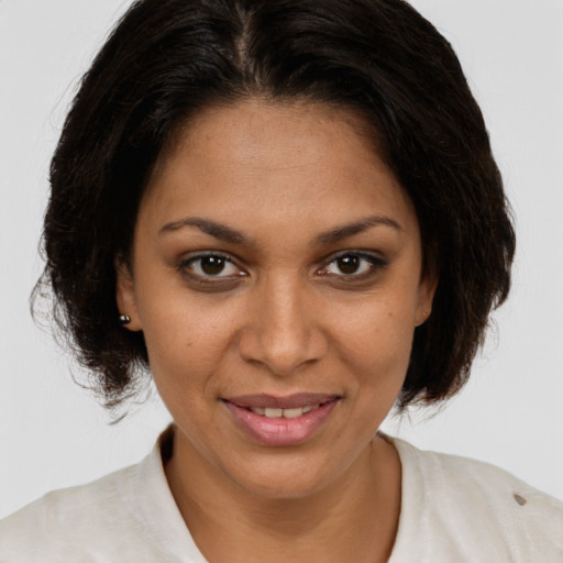 Joyful black adult female with medium  brown hair and brown eyes