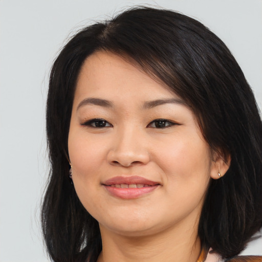 Joyful asian young-adult female with medium  brown hair and brown eyes