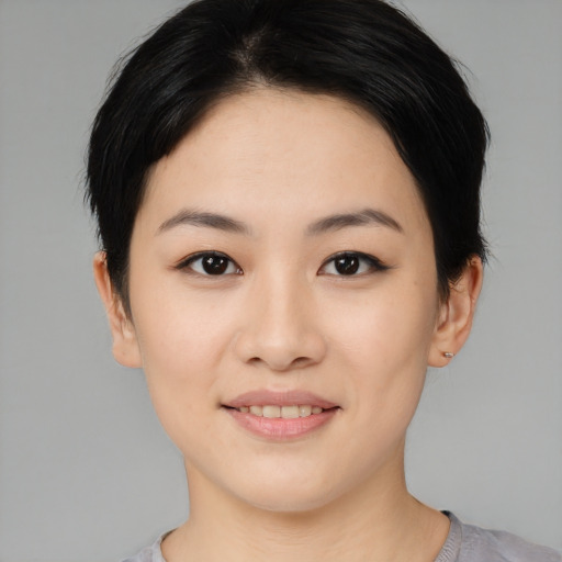 Joyful asian young-adult female with short  black hair and brown eyes