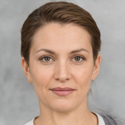 Joyful white adult female with short  brown hair and grey eyes