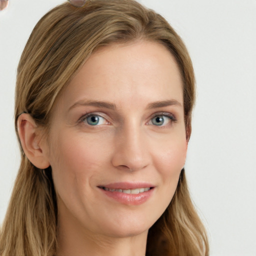 Joyful white young-adult female with long  brown hair and blue eyes