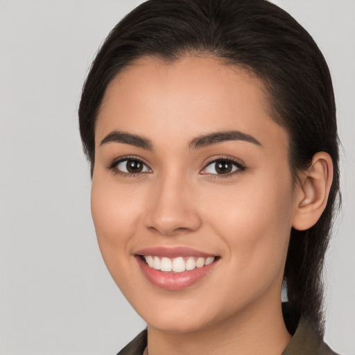 Joyful white young-adult female with long  brown hair and brown eyes