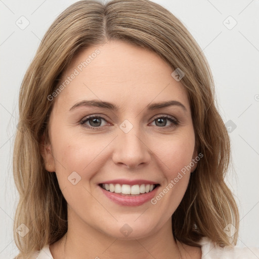 Joyful white young-adult female with medium  brown hair and green eyes