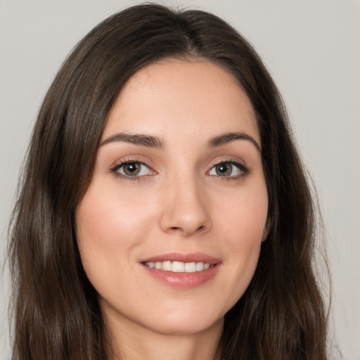 Joyful white young-adult female with long  brown hair and brown eyes