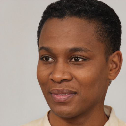 Joyful black young-adult female with short  black hair and brown eyes