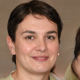 Joyful white adult male with medium  brown hair and brown eyes