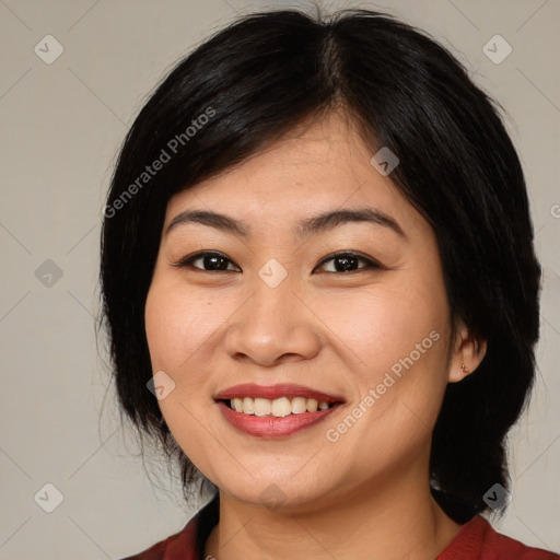 Joyful asian young-adult female with medium  black hair and brown eyes