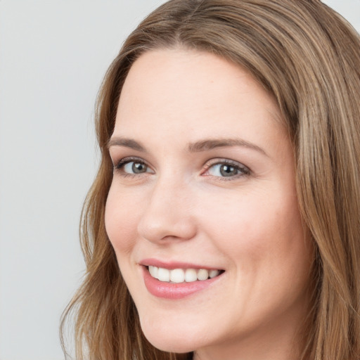 Joyful white young-adult female with long  brown hair and grey eyes