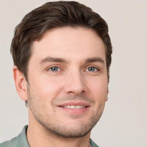 Joyful white young-adult male with short  brown hair and grey eyes