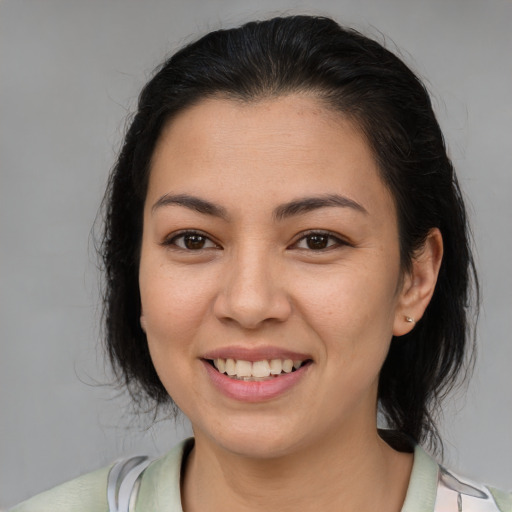 Joyful latino young-adult female with medium  brown hair and brown eyes
